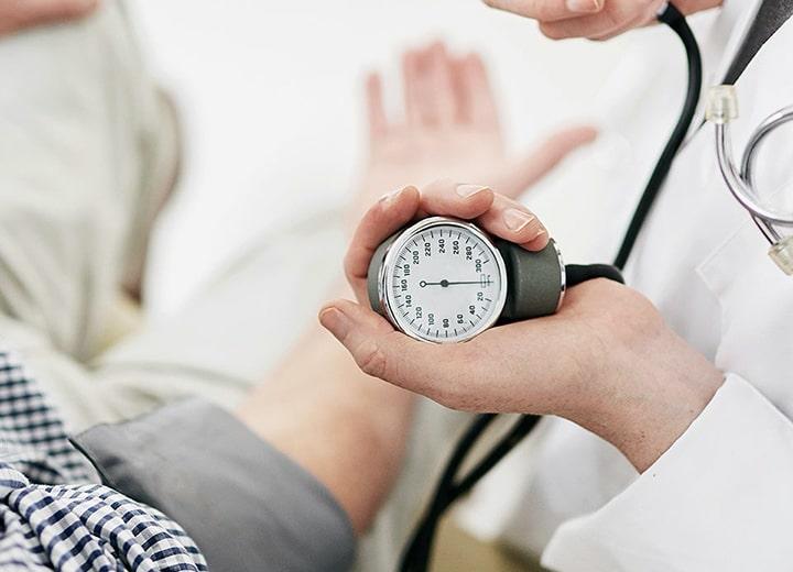 Doctor using a blood pressure cuff on a patient